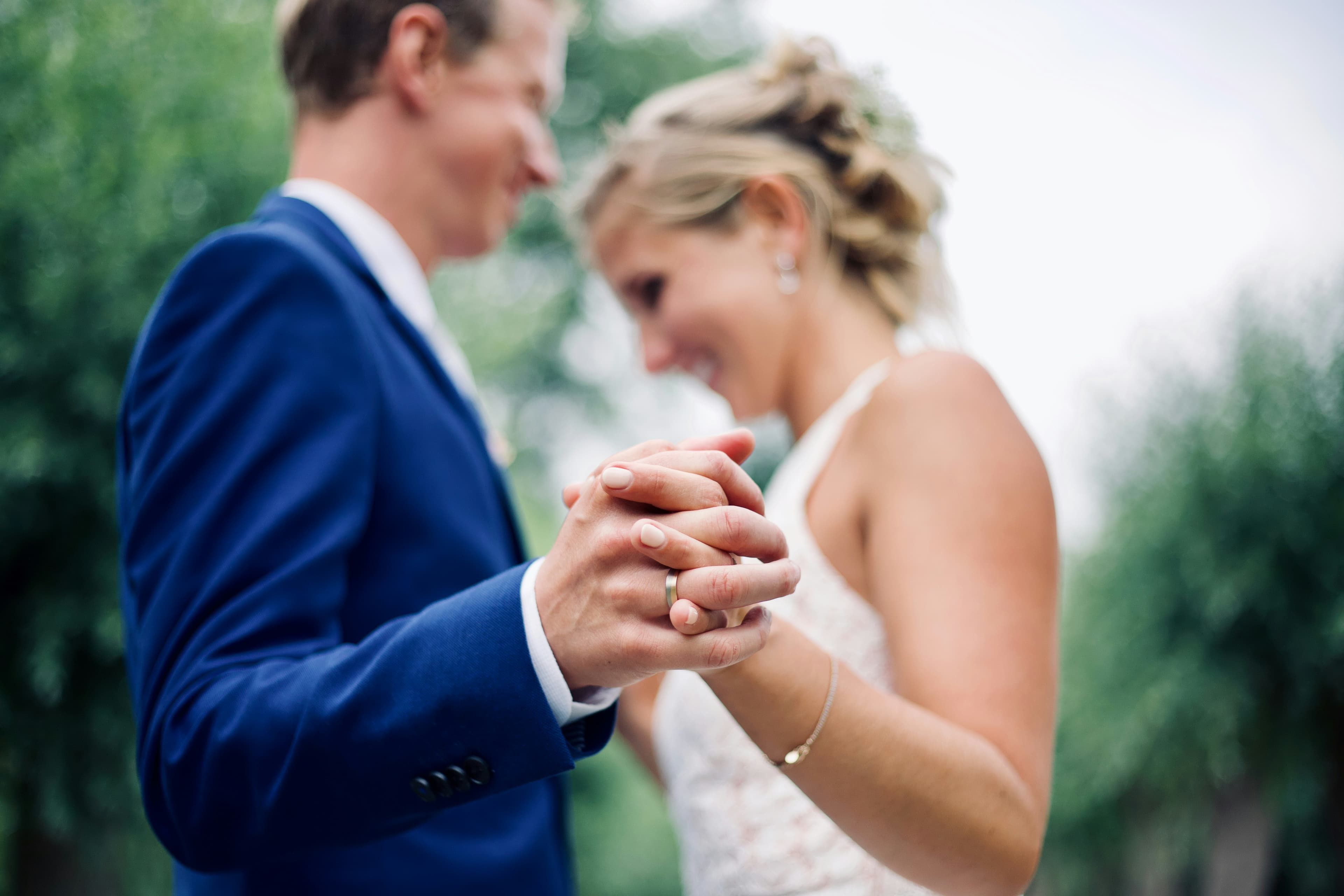 Bride and groom holding hands during wedding ceremony with live acoustic music performance